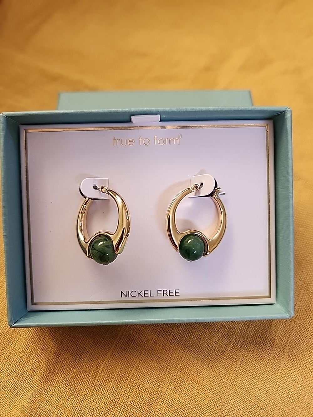True to Form Gold Hoop Earrings with Green Stone Accent
